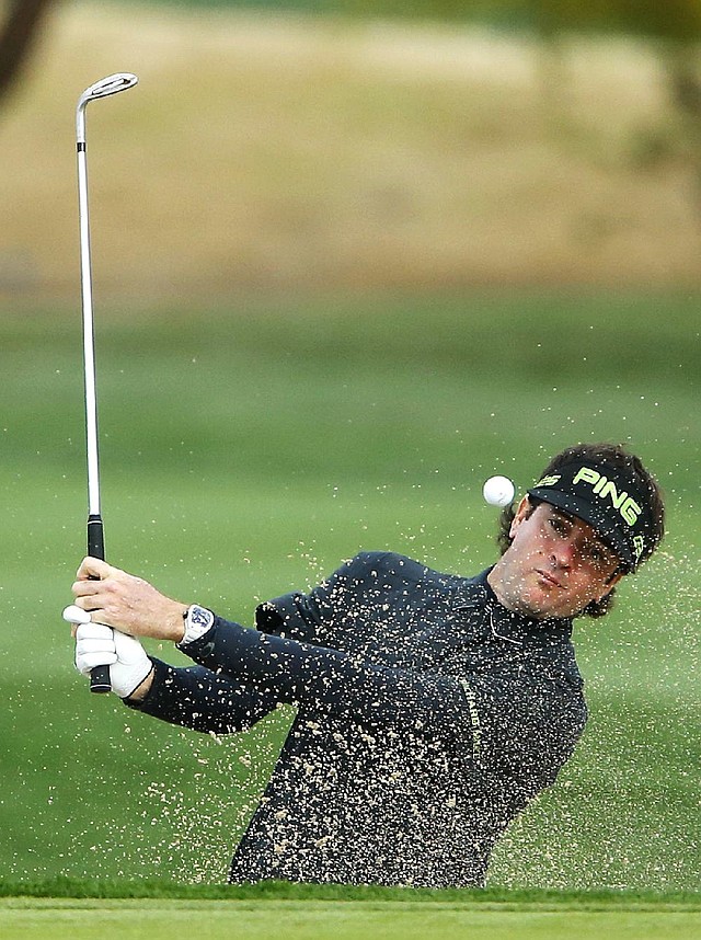Bubba Watson blasts from the sand on the 15th hole in the second round of the Phoenix Open. Watson followed an opening 64 with a 66 and is tied for the lead with Matt Jones. 