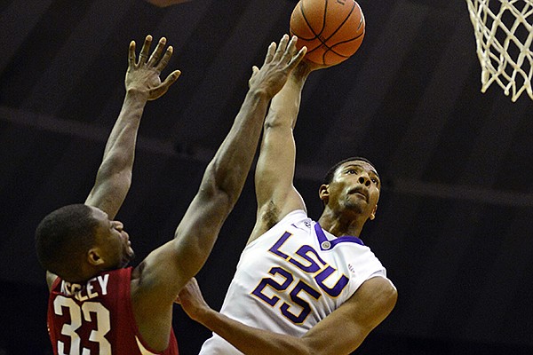 LSU's Jordan Mickey (25) shoots over Arkansas' Moses Kingsley during an NCAA college basketball game on Saturday, Feb. 1, 2014, in Baton Rouge, La. (AP Photo/The Advocate, Catherine Threlkeld)