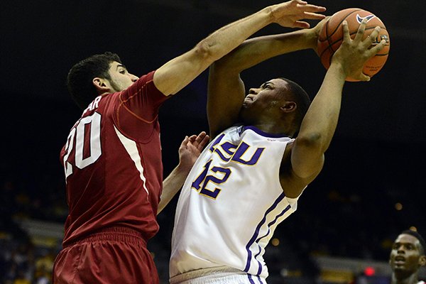 Arkansas' Kikko Haydar fouls LSU's Jarell Martin during an NCAA college basketball game on Saturday, Feb. 1, 2014, in Baton Rouge, La. (AP Photo/The Advocate, Catherine Threlkeld)