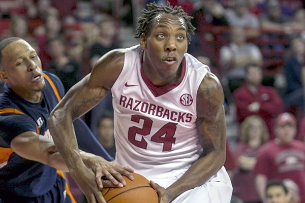  In this Dec. 19, 2013, file photo, Arkansas' Michael Qualls (24) looks to the basket as Tennessee-Martin's Terence Smith attempts a steal during the second half of an NCAA college basketball game in Fayetteville, Ark. Qualls led Arkansas in its nonconference schedule but has struggled in Southeastern Conference play. (AP Photo/Gareth Patterson, File)