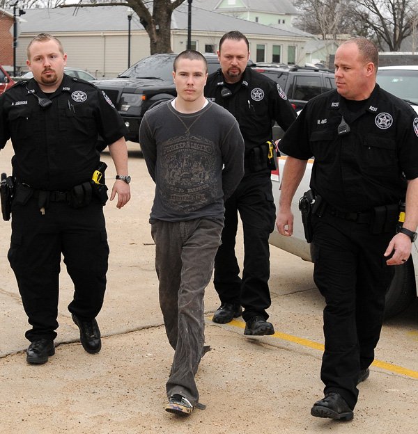 Officers from the Benton County Sheriff's Office escort Zachary Holly into the Benton County Courthouse Annex in Bentonville for a hearing in Judge Brad Karren's courtroom on Friday January 31, 2014. Holly is charged with the November 2012 killing 6-year-old Jersey Bridgeman.