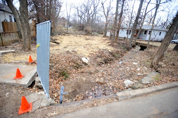 A 60 foot section of Scull Creek crosses the front of the vacant lot at 517 N Walnut St in Fayetteville.  Because the section of creek is on the cites protected streams map it is preventing construction activities within 50 feet of the stream bank.