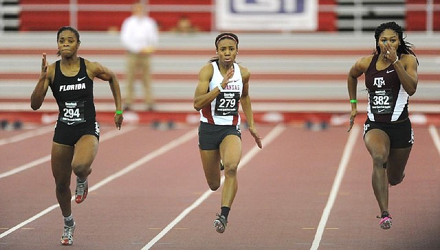 NWA Media/ANDY SHUPE - Arkansas freshman Regine Williams (279) runs alongside Shayla Sanders of Florida, left, and Aaliyah Brown of Texas A&M in the 60 meters during the Razorback Invitational Saturday, Feb. 1, 2014, at the Randal Tyson Track Center in Fayetteville.