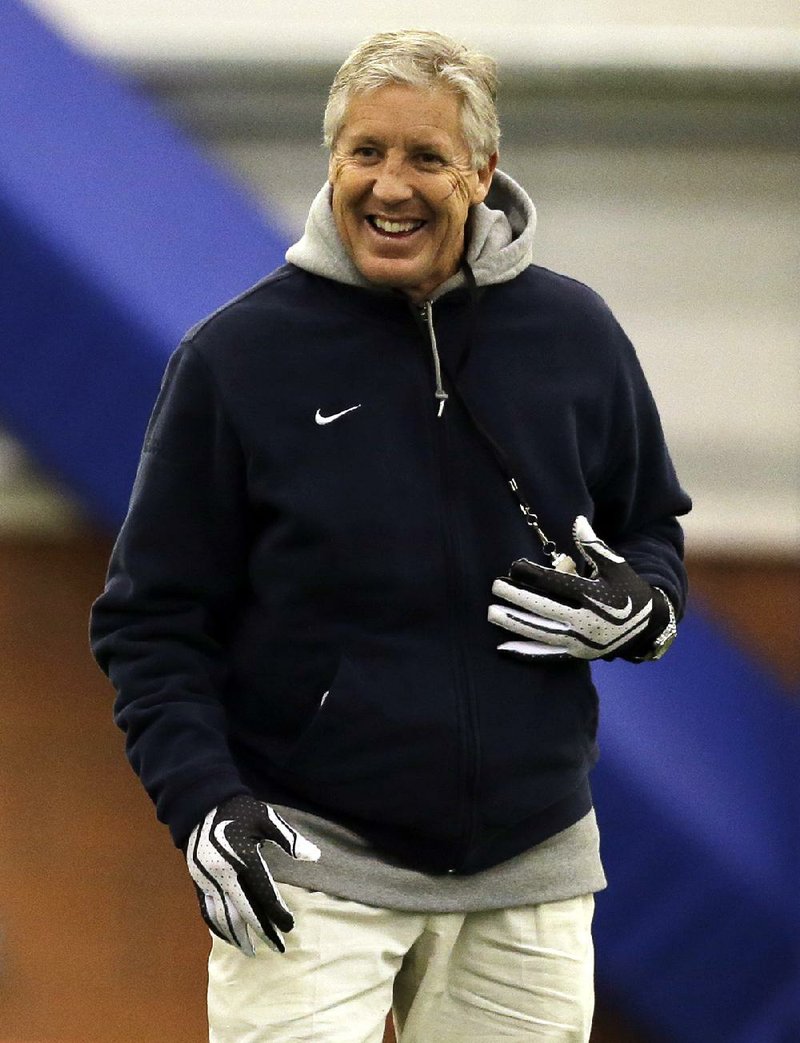 Seattle Seahawks head coach Pete Carroll smiles as his teams warms up for NFL football practice Thursday, Jan. 30, 2014, in East Rutherford, N.J. The Seahawks and the Denver Broncos are scheduled to play in the Super Bowl XLVIII football game Sunday, Feb. 2, 2014. (AP Photo)