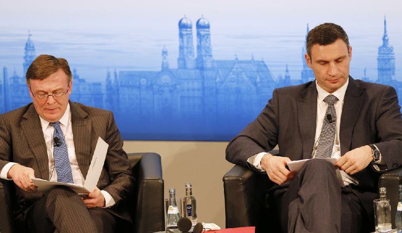 Ukrainian Foreign Minister Leonid Kozhara (left) and opposition leader Vitali Klitschko attend the Munich Security Conference on Saturday. 