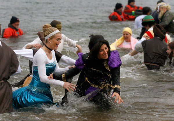 Crystal Lewis (left) and Heather Coon, both with Ruth Barker Middle School, quickly make their way out of the water on Saturday, Feb. 9, 2013, during the 15th annual Beaver Lake Polar Plunge at the Prairie Creek Swim Area at Beaver Lake in Rogers. The event had over 400 participants that raised over $50,000 for Special Olympics Arkansas.