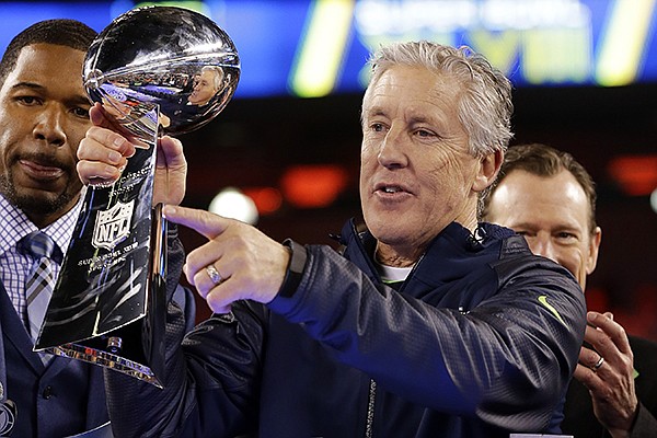 Seattle Seahawks head coach Pete Carroll raises the Vince Lombardi Trophy after the NFL Super Bowl XLVIII football game against the Denver Broncos, Sunday, Feb. 2, 2014, in East Rutherford, N.J. The Seahawks won 43-8. (AP Photo/Matt Slocum)