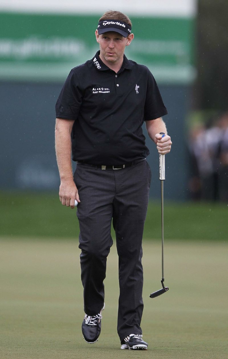 Stephen Gallacher of Scotland reacts after he wins the final round of the Dubai Desert Classic golf tournament in Dubai, United Arab Emirates, Sunday Feb. 2, 2014. Gallacher shot a final round 72 Sunday to become the first player to successfully defend the Dubai Desert Classic title. (AP Photo/Kamran Jebreili)
