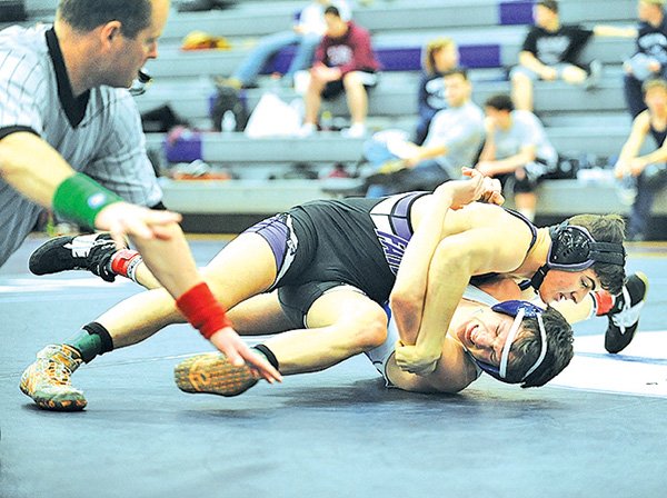 STAFF PHOTO ANDY SHUPE 
Jaxson Nolen of Fayetteville, top, wrestles Gary Fredrick of Rogers during their match Saturday at Fayetteville High School.