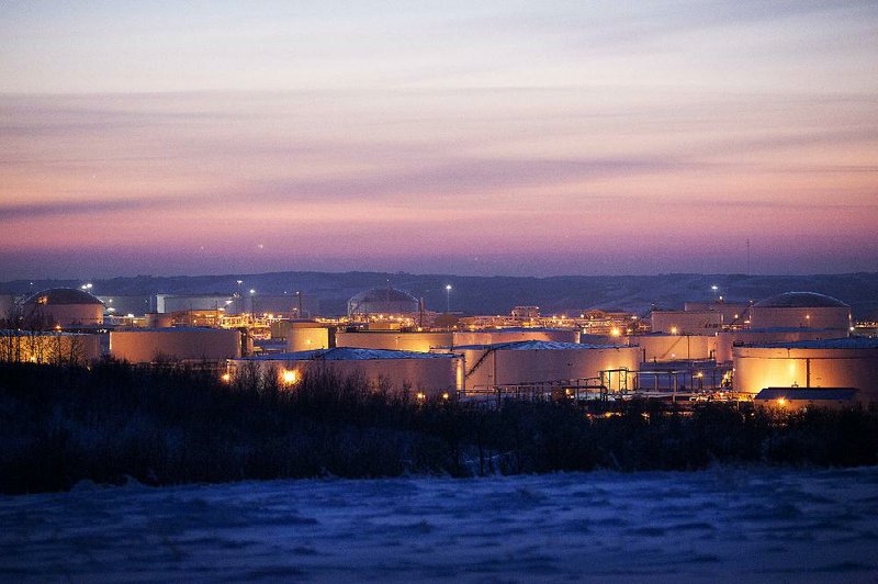 The Hardisty tank farm, which includes the TransCanada Corp. Hardisty Terminal 1, stands at dusk in Hardisty, Alberta, Canada, on Friday, Dec. 6, 2013. Canadian heavy crude reached its strongest level in more than two months on the spot market as a pipeline connection to the U.S. Gulf Coast began filling with crude ahead of its startup next month. Photographer: Brett Gundlock/Bloomberg