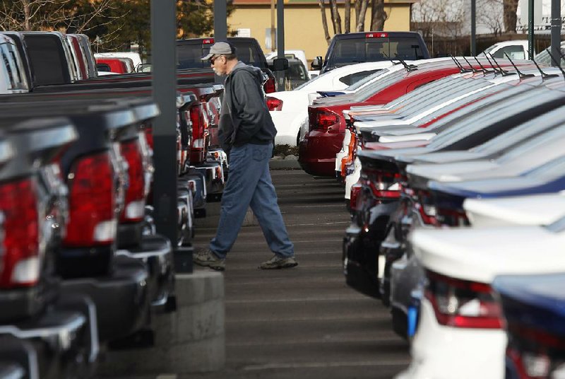 FILE - In this Sunday, Jan. 20, 2013, file photo, a buyer moves between rows of Ram pickup trucks and Dart sedans at a Dodge dealership in Littleton, Colo. Chrysler says its U.S. sales rose 8 percent in January 2014, as it posted strong growth despite the frigid weather that gripped much of the nation. (AP Photo/David Zalubowski, File)