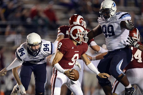 Springdale Har-Ber defensive linemen Jake Hall, left, and Josh Frazier, right, pressure Owasso quarterback Jaylen Lowe during the Wildcats' scrimmage Friday, Aug. 24, 2012, against the Rams at Union-Tuttle Stadium in Tulsa, Okla. Hall with sign with Arkansas and Frazier will sign with Alabama on Wednesday. 