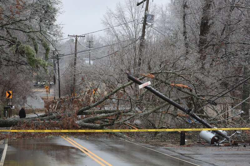  A large ice-covered hardwood tree fell over and landed on a power line, snapping the utility pole off and causing the lines and transformers to land on the street in the 10,000 block of Mablevale Pike in Little Rock Tuesday, Feb. 4, 2013.