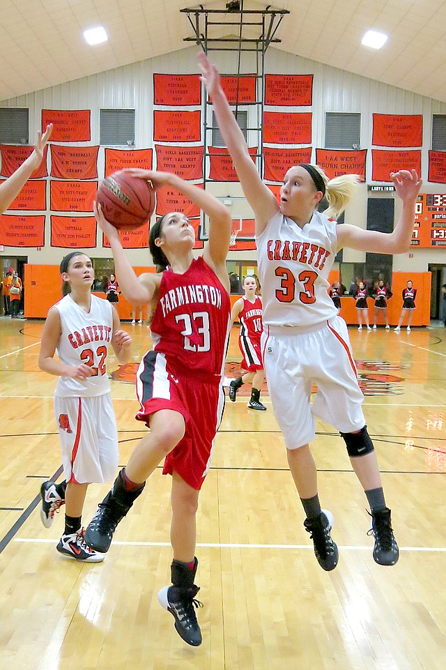 Photo by Randy Moll Gravette junior, Kylee Davis, attempts to block a shot by Farmington junior, Laney Dorman, during play in Gravette on Friday. Gravette s Samantha Pruitt looks on.