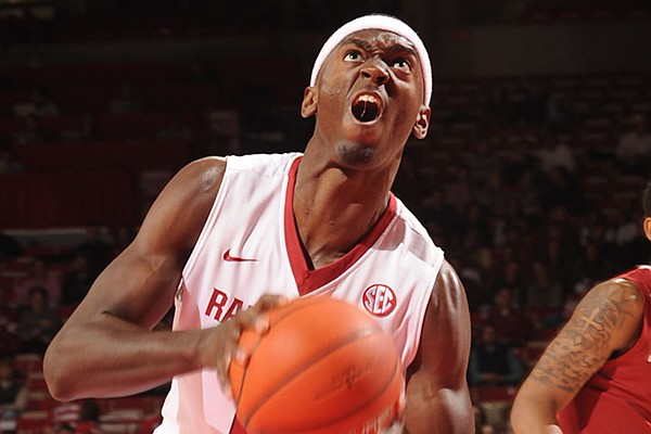 Arkansas freshman Bobby Portis, left, drives to the basket as Alabama junior Carl Engstrom defends during the first half of play Wednesday, Feb. 5, 2014, in Bud Walton Arena in Fayetteville.