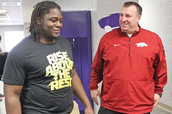 Arkansas Razorbacks head football coach Bret Bielema talks with El Dorado High School's Bijhon Jackson, a Razorback commit, during a visit at El Dorado High School on Thursday, Jan. 23, 2014.