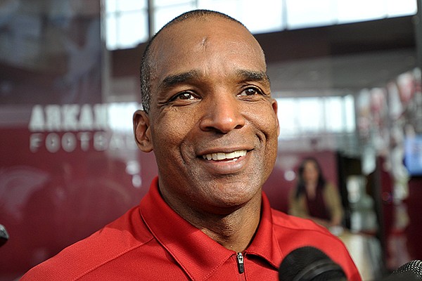 Arkansas linebackers coach Randy Shannon talks with reporters following the Arkansas Razorbacks' national signing day press conference at the Fred Smith Center in Fayetteville.