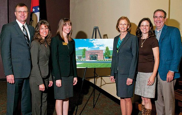 COURTESY PHOTO 
Daniel and Dayle Shewmaker, from left, Amy Benincosa, Melba Shewmaker and Shari and Lamar Steiger stand with a rendering of the Southern Region National Child Protection Training Center. The event in October 2012 announced a $1.3 million gift from Melba Shewmaker toward the training center’s $3 million capital campaign.