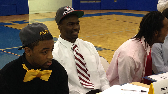 North Little Rock running back Juan Day smiles prior to a signing ceremony where he made his commitment to Arkansas official on Wednesday morning. He's flanked by Kavin Alexander (left), who signed with Arkansas-Pine Bluff and Josh Williams (right), who signed with Central Oklahoma.
