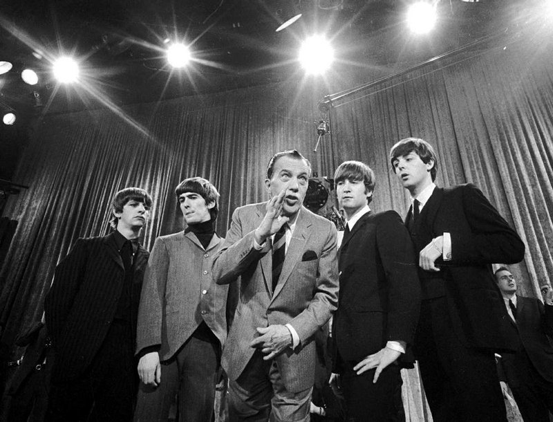 In this Feb. 9, 1964, file photo, Ed Sullivan (center) stands with The Beatles (from left) Ringo Starr, George Harrison, John Lennon and Paul McCartney, during a rehearsal for the British group’s first American appearance, on The Ed Sullivan Show, in New York. CBS is planning a two-hour special on Sunday to mark the 50th anniversary. 