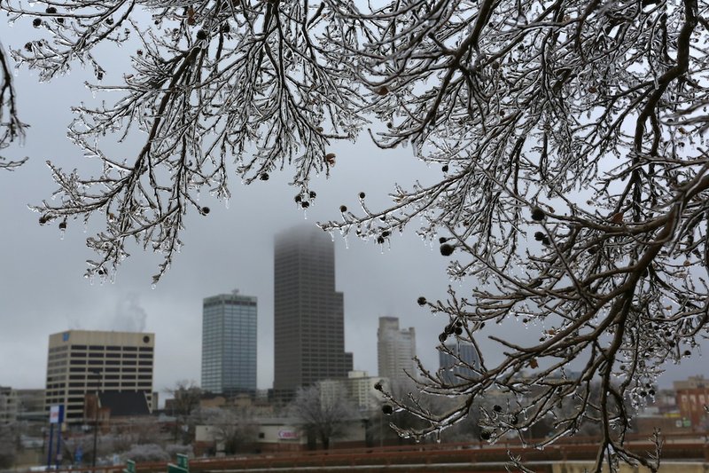 The Little Rock skyline is framed by the ice-covered branches of a small tree along I-30 in Little Rock Tuesday, Feb. 4, 2014.