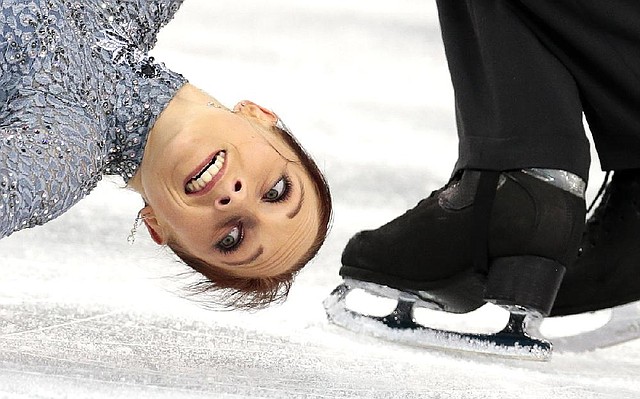 Germany’s Maylin Wende comes close to Daniel Wende’s skate in the pairs short program in the team figure skating event Thursday at Iceberg Skating Palace in Sochi. The Germans are fifth in the team standings. 
