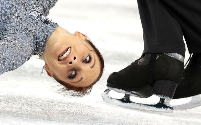 Germany’s Maylin Wende comes close to Daniel Wende’s skate in the pairs short program in the team figure skating event Thursday at Iceberg Skating Palace in Sochi. The Germans are fifth in the team standings. 