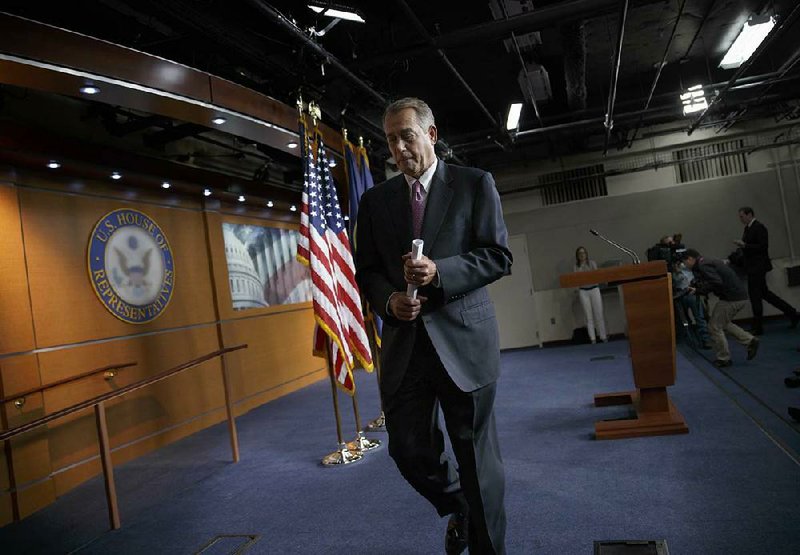 House Speaker John Boehner of Ohio leaves a news conference on Capitol Hill on Thursday after saying it will be difficult to pass immigration legislation this year, dimming prospects for one of President Barack Obama’s top domestic priorities. 