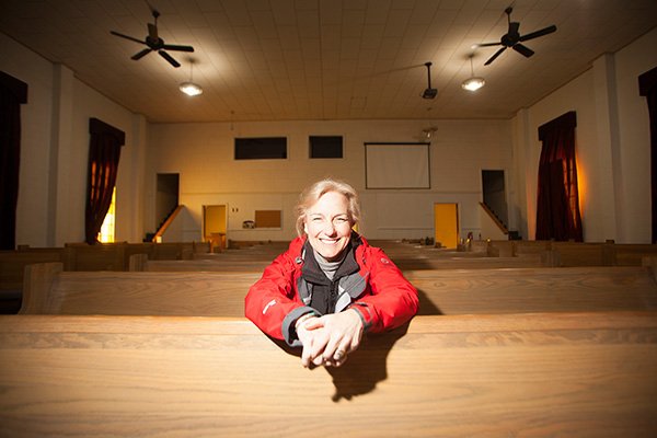 Arkansas Democrat-Gazette/RYAN McGEENEY 
Delia Haak, executive director of the Illinois River Watershed Partnership, sits inside the former Lakeview Baptist Church in Cave Springs. The church building will serve as the group’s new Watershed Learning Center, the partnership announced Wednesday.