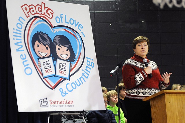 Debbie Rambo, executive director for the Samaritan Community Center, talks about the impact the SnackPack for Kids program has made on the community Friday, Feb. 7, 2014, at R. E. Baker Elementary in Bentonville in celebration of the delivery of the one millionth SnackPack from the Samaritan Community Center.