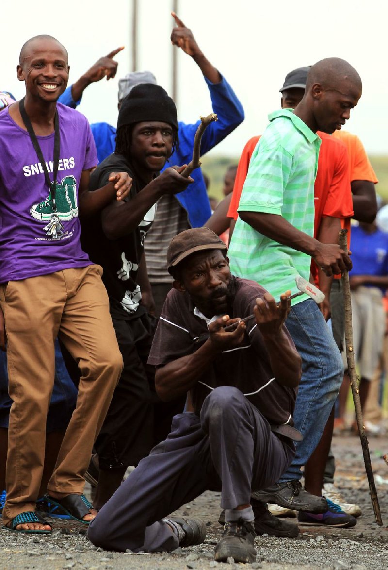 Singing protesters confront police Thursday near Pretoria as poor South Africans continue their demonstrations. 