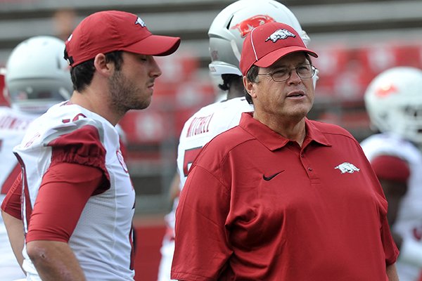 Arkansas offensive coordinator Jim Chaney, right, talks with quarterback Brandon Allen prior to a game against Rutgers on Sept. 21, 2013 at Highpoint Solutions Stadium in Piscataway, N.J. 