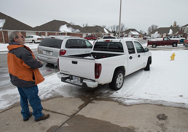 Michael Sidney, code enforcement officer, looks toward a property Friday, Feb. 7, 2014 where a truck is illegally parked in the grass too close to a file hydrant in Springdale. Sidney issued a warning to the property giving them time to move the truck before issuing a ticket.