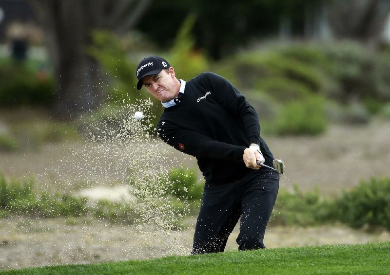 Jimmy Walker hits out of a sand trap on the fifth hole Saturday at the AT&T Pebble Beach National Pro-Am. He leads the tournament by six strokes over Tim Wilkinson and Hunter Mahan. 