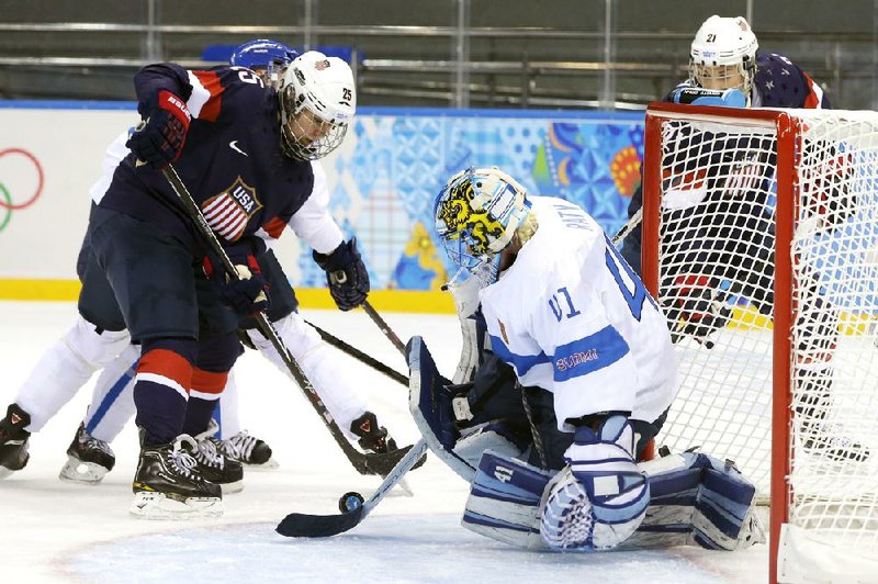 Goalie Noora Raty of Finland blocks a shot by Alex Carpenter of the United States in the Americans’ 3-1 victory in women’s hockey at the Shaba Arena in Sochi on Saturday. 