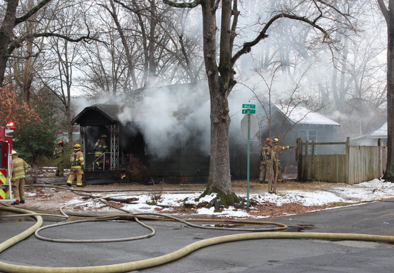 Firefighters work to extinguish a house fire Sunday afternoon in North Little Rock.