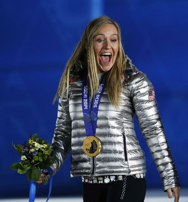 Gold medalist in the women's snowboard slopestyle Jamie Anderson of the United States smiles during the medals ceremony at the 2014 Winter Olympics, Sunday, Feb. 9, 2014, in Sochi, Russia. (AP Photo/Morry Gash)