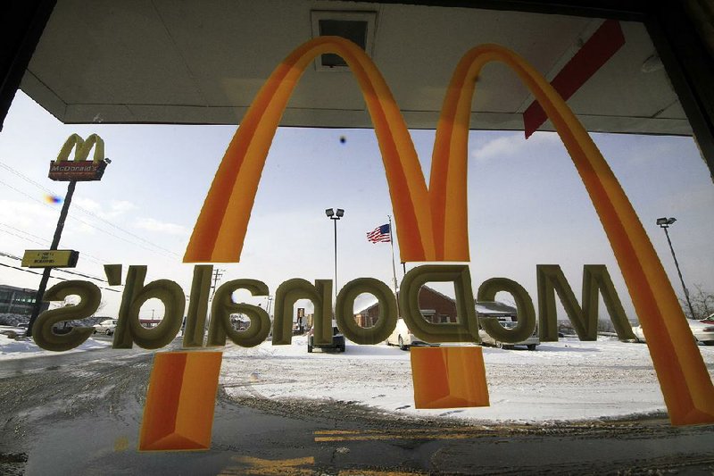 In this Tuesday, Jan. 21, 2014, photo, the McDonald's Golden Arches logo is placed on a window at a McDonald's restaurant in Robinson Township, Pa. McDonald's says bad weather hurt its U.S. sales performance in January, representing another setback as the fast-food chain fights to fend off rivals and get its menu right.  (AP Photo/Gene J. Puskar)