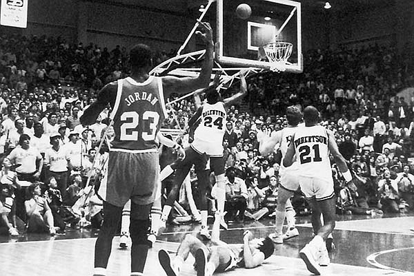 Charles Balentine (24) hits a go-ahead jumper with 4 seconds remaining as Michael Jordan (23) watches during Arkansas' 65-64 win over North Carolina on Feb. 12, 1984 in Pine Bluff. 