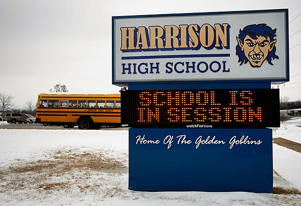 NWA Media/JASON IVESTER 
With snow and ice still on the ground, the sign out front welcomes students Saturday at Harrison High School. A number of districts in Northwest Arkansas opened Monday with limited bus service because of slick rural roads.