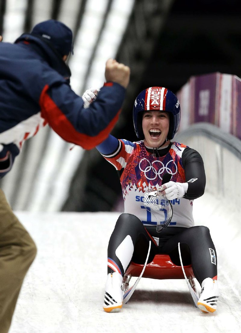 American Erin Hamlin is greeted by her coach after finishing her final run to win the bronze medal in women’s luge. 