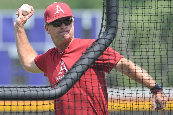 Dave Van Horn throws batting practice Sunday, June 19, 2012 at Bellevue East High School in Omaha, Neb.