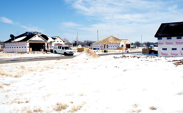 Photo by Dodie Evans Three of the four new homes under construction in Patriot Park subdivision in Gravette are pictured.