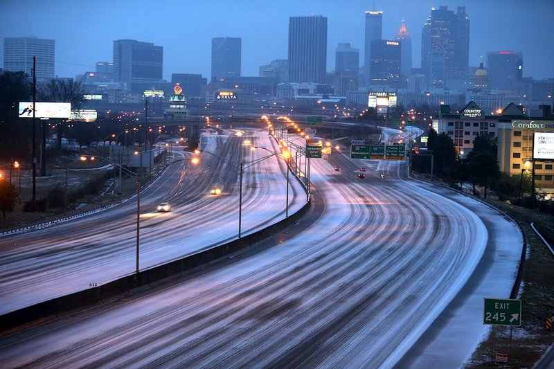 Sparse traffic makes its way on the Interstate 75/85 connector just south of downtown Atlanta, Wednesday morning, Feb. 12, 2014. A combination of sleet, snow and freezing rain was expected to coat power lines and tree branches with more than an inch of ice between Atlanta and Augusta.