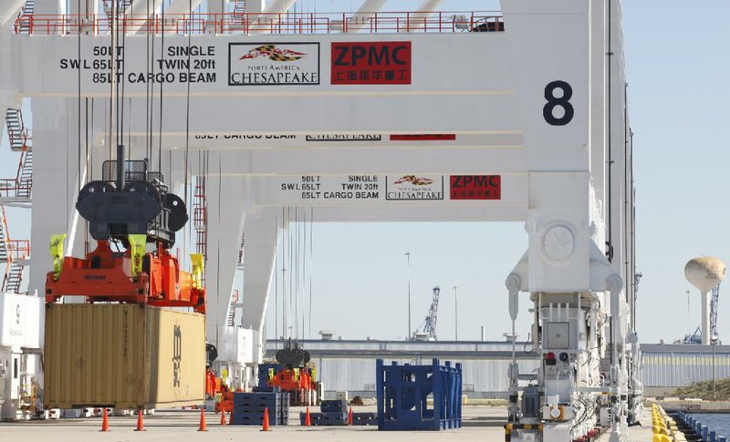 New cranes lift shipping containers during testing in late 2012 at the port in Baltimore. The 400-foot cranes were installed to accommodate larger ships that will be traveling through a wider Panama Canal when the canal project is complete. 