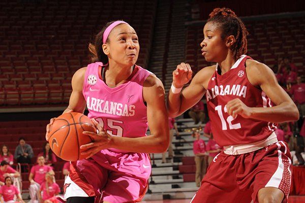 Arkansas freshman Kelsey Brooks (15) drives to the basket as Alabama senior Shafontaye Myers defends during the first half of play Thursday, Feb. 13, 2014, in Bud Walton Arena in Fayetteville.