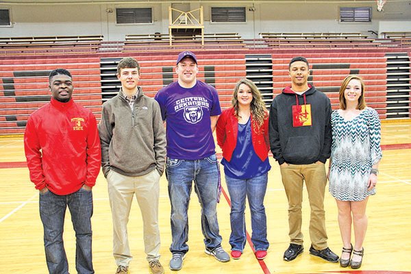 Submitted Photo
Cua Rose, left, of Springdale High, Matt Sherry, Josiah Wymer, Kelcee Thompson, Deandre Murray and Taylor Wyatt were recognized for their accomplishments in a signing ceremony Tuesday at Bulldog Gym in Springdale.
