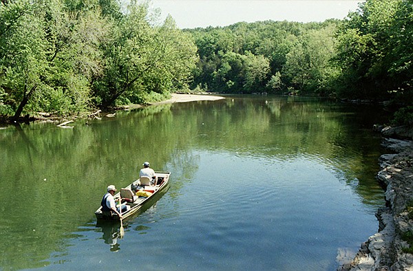 FILE PHOTO FLIP PUTTHOFF 
JD Fletcher paddles his john boat during a Kings River float trip in 1998. Gary Johnson of Rogers is in the bow. Fletcher liked to call the Kings River his “office.”