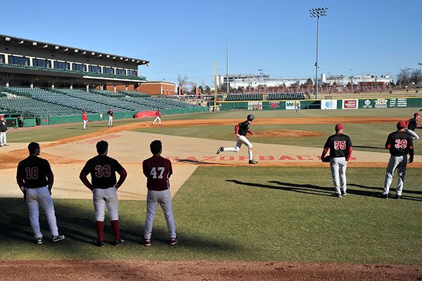 Arkansas' baseball team runs situation drills during the first practice of the season on Friday, Jan. 24, 2014 at Baum Stadium in Fayetteville.