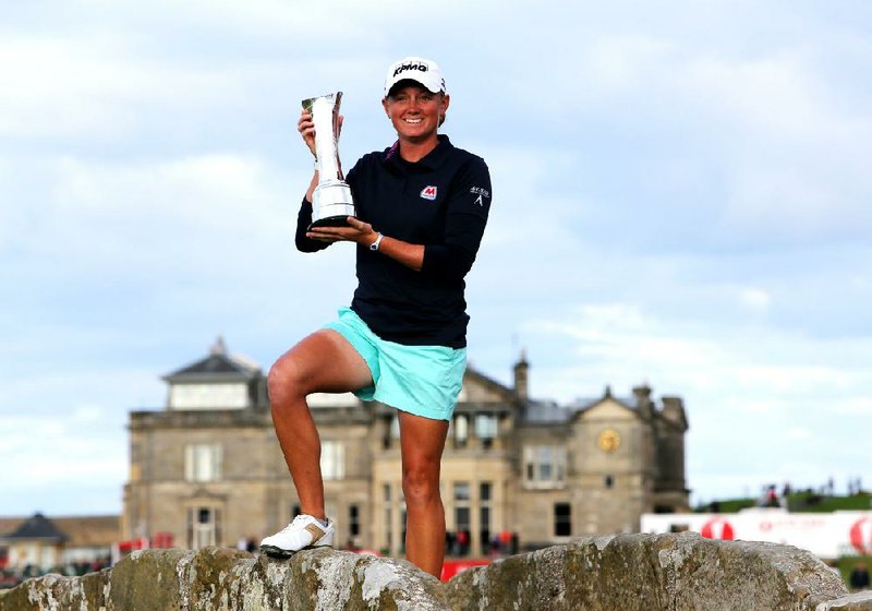 Stacy Lewis of the US poses with the trophy after winning Women's British Open golf championship on the Old Course at St Andrews, Scotland, Sunday Aug. 4, 2013. (AP Photo/Scott Heppell)